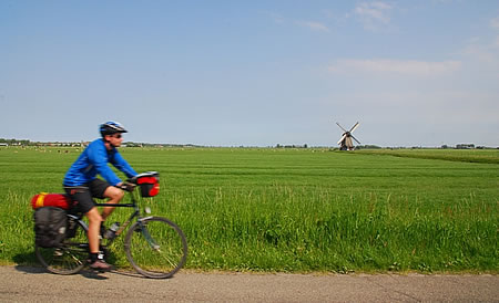 Cycling in Holland with a windmill background.