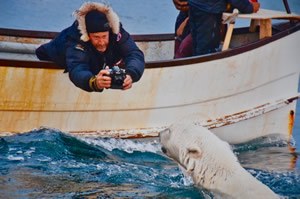 Mario Cyr filming in boat.