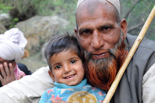 Van Gujjar man with child in India.