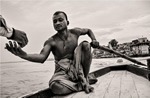 Narrative of man rowing a boat in Varanasi, India.