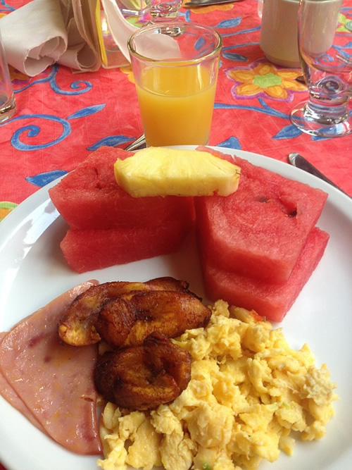 Costa Rican breakfast with eggs, plantains and fruit.