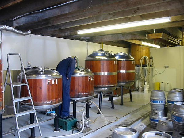 Brewmaster at work in brewery in Scotland.