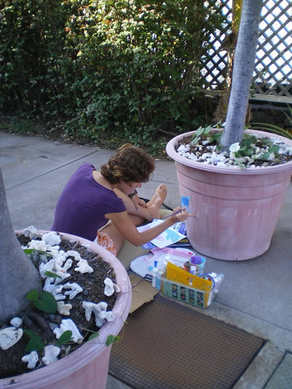 Caretaking job: Author painting pot and property.