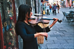 Photo of violinist playing on street in Poland.