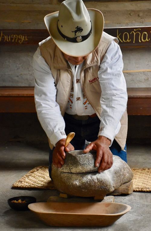 Alfonso grinding corn on the stone "mill."