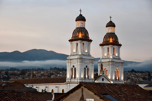 The towers of the Santa Domingo church with a Cuenca skyline in the background