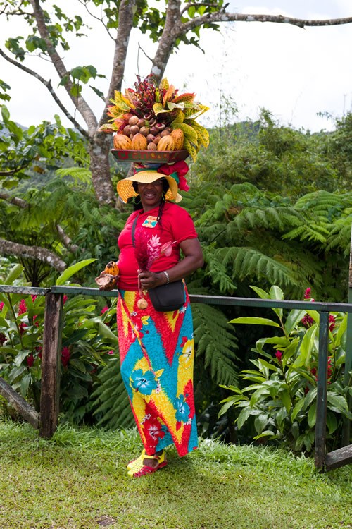 A Grenadian woman shows off the island’s abundance of spices.