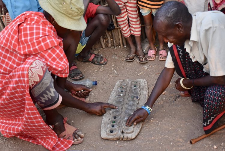 Villagers playing a game called bao