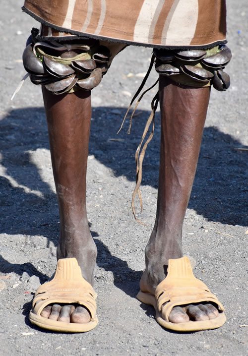 Turkana men perform dances with bells on knees