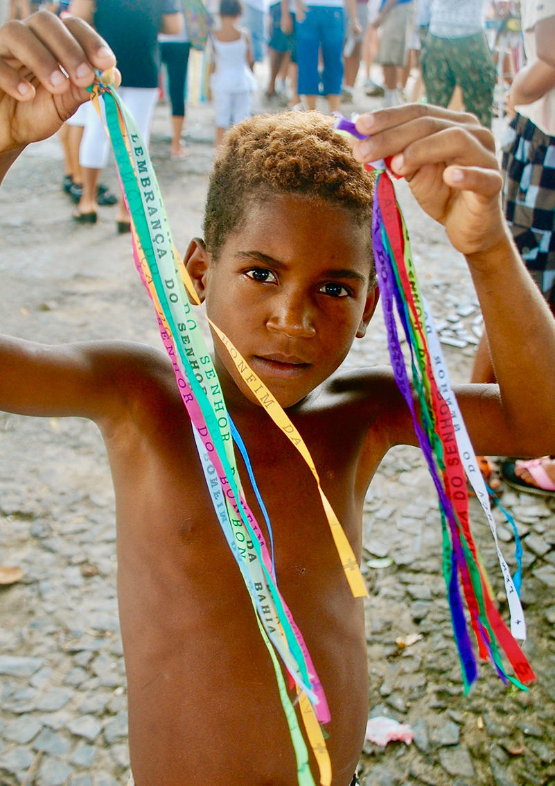 Boy with ribbons in Houses in Salvador de Bahia, Brazil