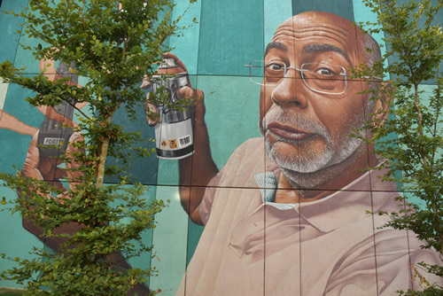 Urban street art. Self-portrain of a man spray painting.