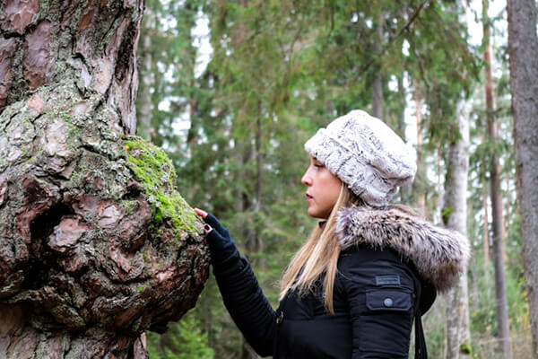 Woman enjoying being in the forest solo in Estonia.