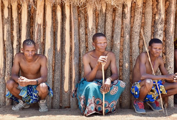 Mugambue men in front of their hut