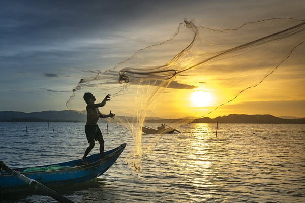 Fishermen at sunset in Vietnam