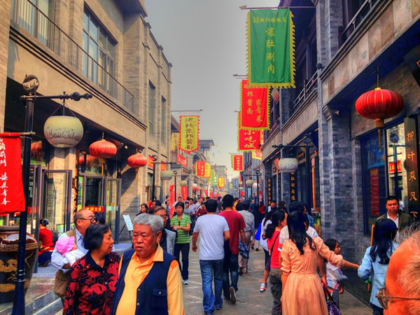 Beijing, China street scene full of people, shops and red lanturns.