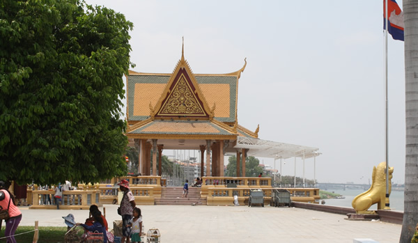Phnom Penh's riverfront in Cambodia with temple.