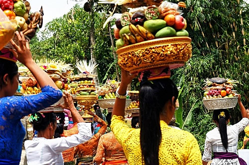Women carrying fruit to ceremony in Bali.