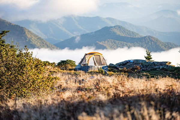 Nomadic living abroad in a tent amidst the mountains.