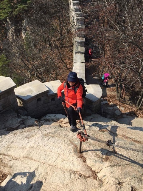 Hiking up a cliff for sport in South Korea.