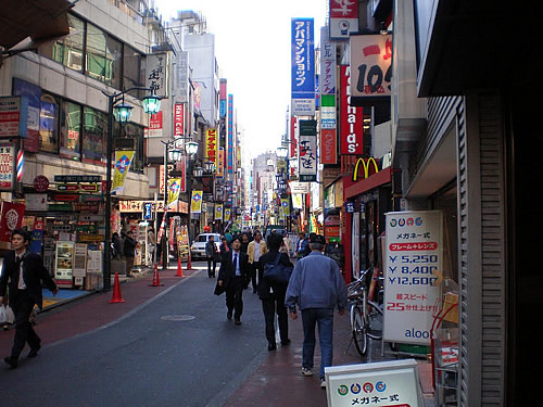 People walking on a small shopping Street in Tokyo.