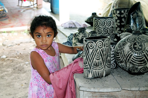 Girl with traditional pottery.