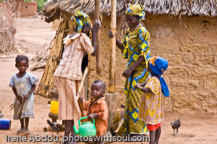 Two Fulani women pounding millet grain.
