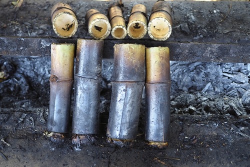 Steaming sticky rice in Bamboo poles