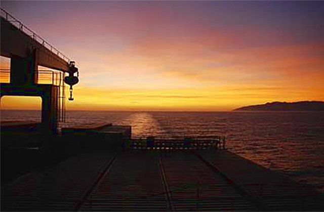 Cargo ship travel with a sunset view