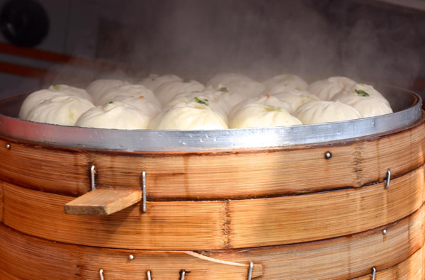 Bamboo steaming basket with dumplings