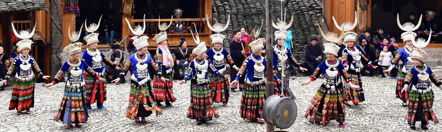 Women dancing at a festival in Guizhou Province, China