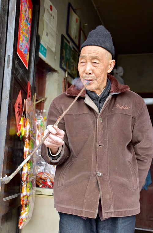 Pipe smoking old Han man in Beizhai