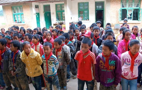 Children assembling in a school yard.