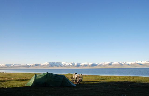 Camping in Kyrgyzstan after cycling all day, with bikes outside tent.