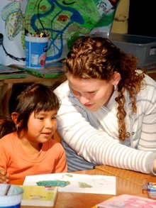 Volunteer teaching Guatemalan child