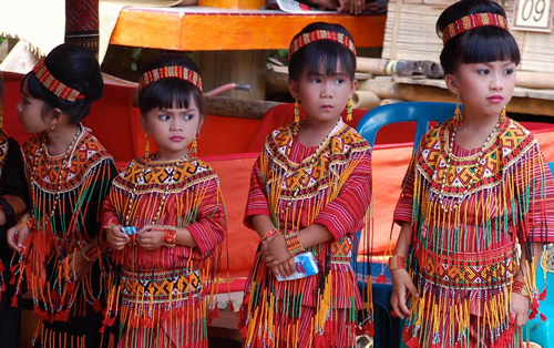 Girls in ceremonial dress for funeral procession
