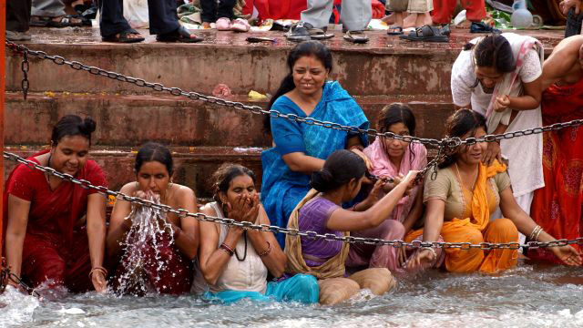 Hindu women bathing in the river at India's massive Kumbh Mela festival.