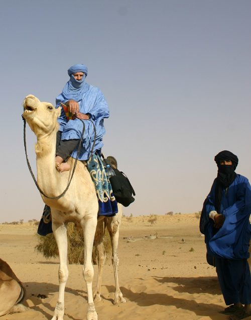Mounted on camel in Sahara with Tuareg