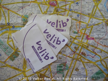 Velib rental tickets on top of a paper map of Paris.