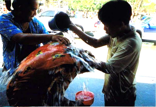 Pouring water on man during the Songkran Festival in Chiang Mai, Thailand.