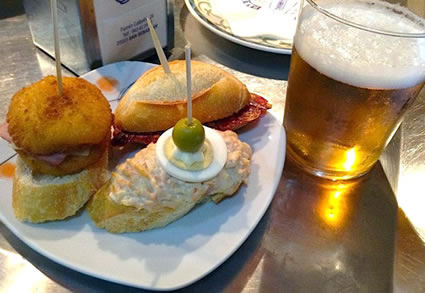 Typical variety of pintxos and a beer