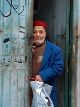 Man in Sfax Medina looking out door