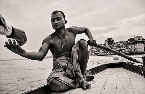 Boatman at dawn on Ganges, India