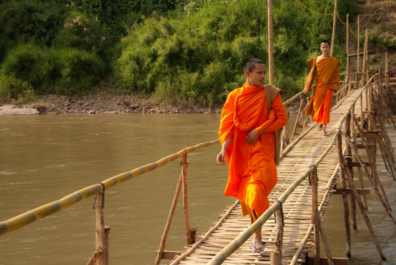 Monks crossing a bridge in Laos