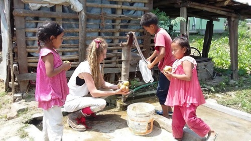 Washing apples with Nepal children