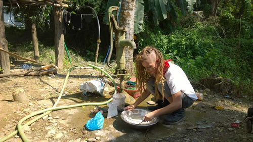 Author making a pancake mix in Chitwan.