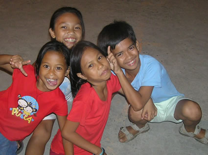 Children clown for camera in the Philippines.