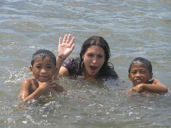 Volunteer swimming with the children in the Philippines.