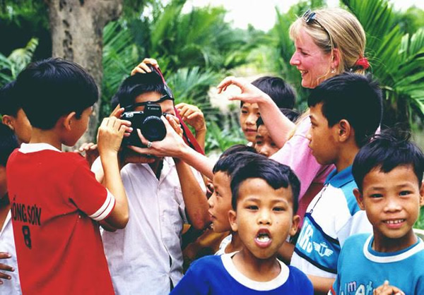Showing children in Vietnam how to take photos