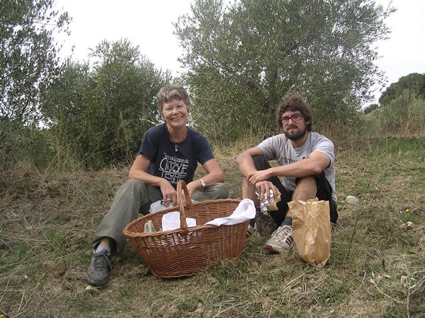 The author and friend volunteering in olive grove with WWOOF in Italy