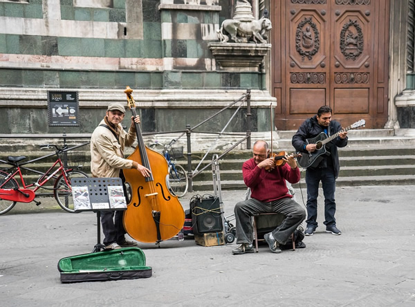 Musicians busking in Italy playing on the street.